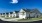 a row of houses with paved driveways and a blue sky in the background