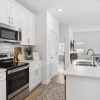 Kitchen with white cabinets and overhead lighting