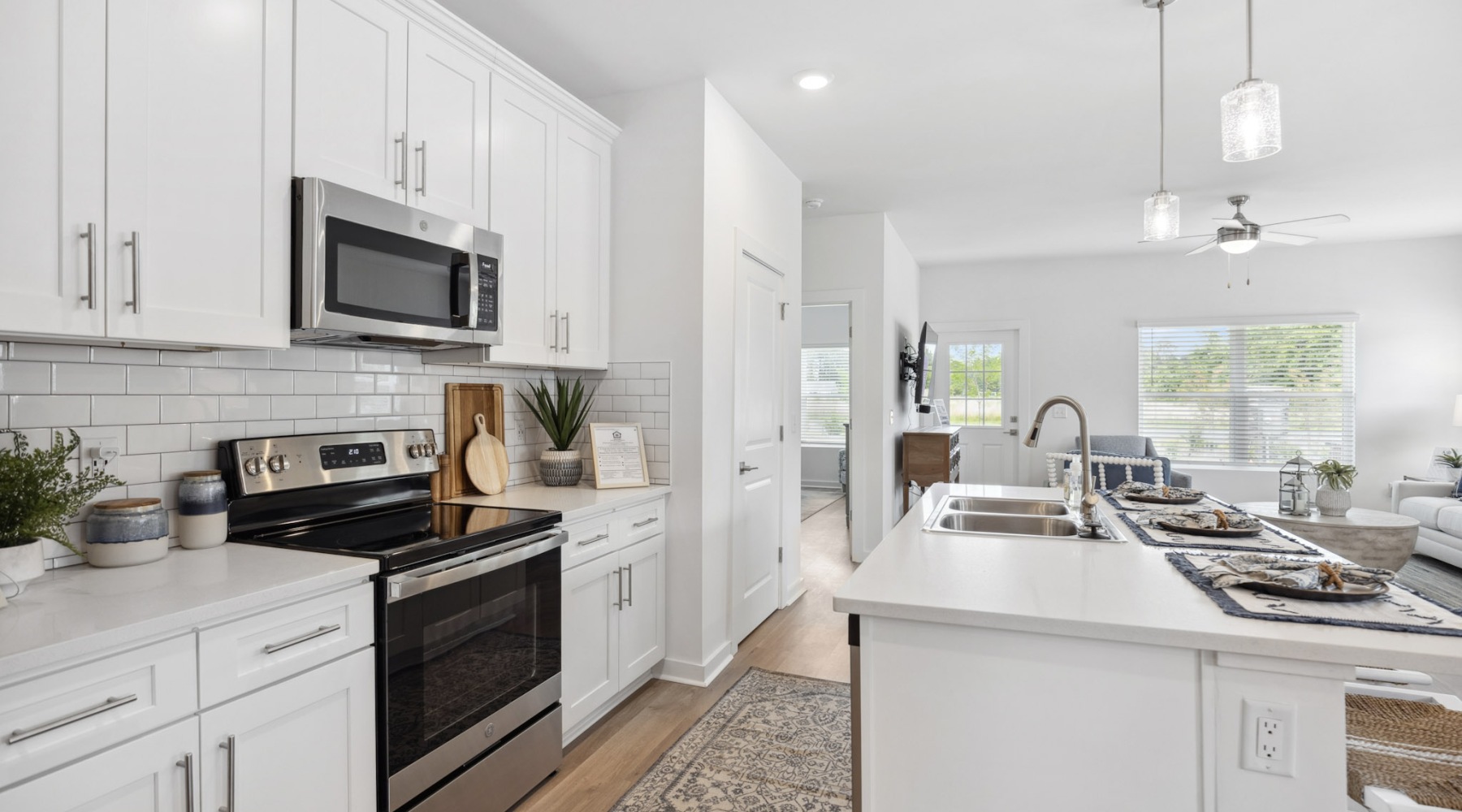 Kitchen with white cabinets and overhead lighting