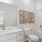 Model bathroom at River Rock at Blume Road homes for rent in Mooresville, NC, featuring white counters and cabinetry.