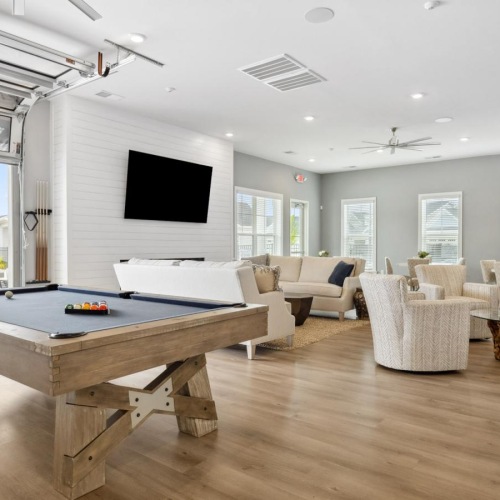 Take advantage of all River Rock at Blume Road has to offer Resident lounge at River Rock at Blume Road homes for rent in Mooresville, NC, featuring wood grain flooring.