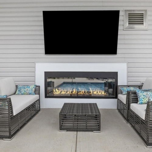 Access to resident-only features Resident lounge at River Rock at Blume Road homes for rent in Mooresville, NC, featuring couches and a flat screen TV.