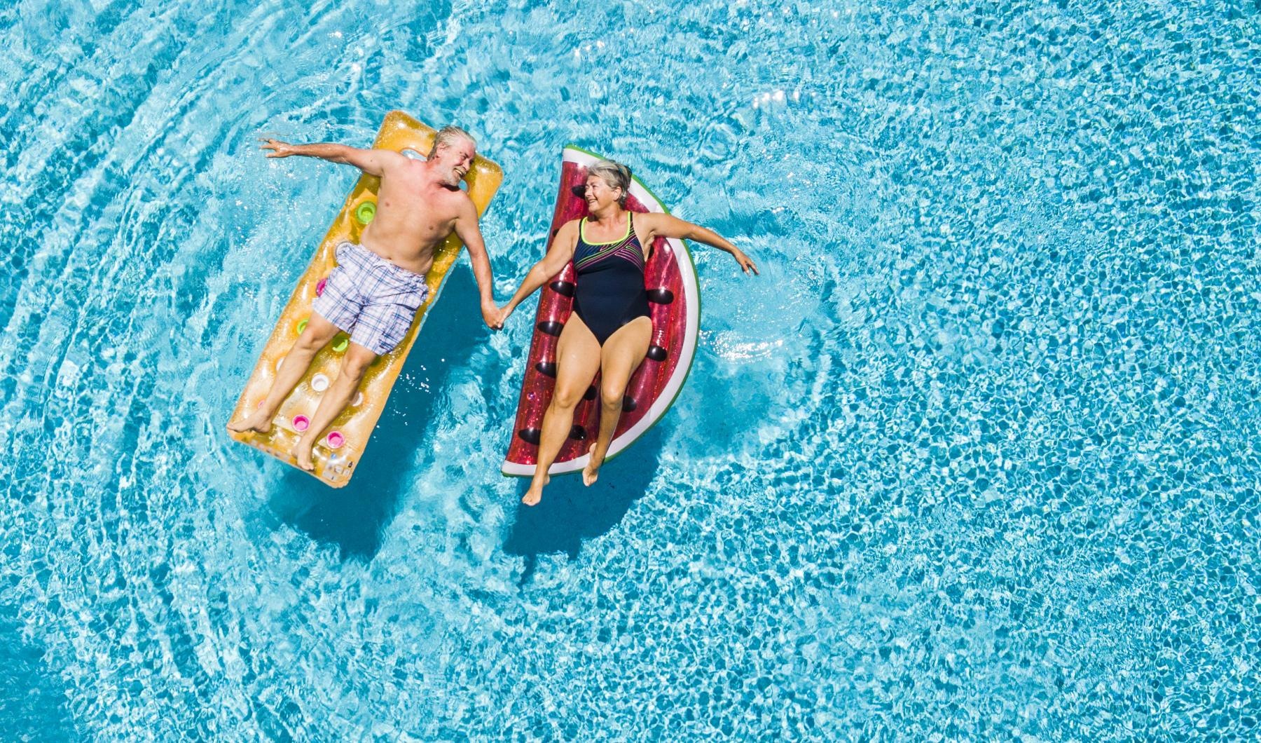 a couple of people in swimsuits in the water