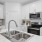 Model kitchen at River Rock at Blume Road homes for rent in Mooresville, NC, featuring stainless steel appliances.